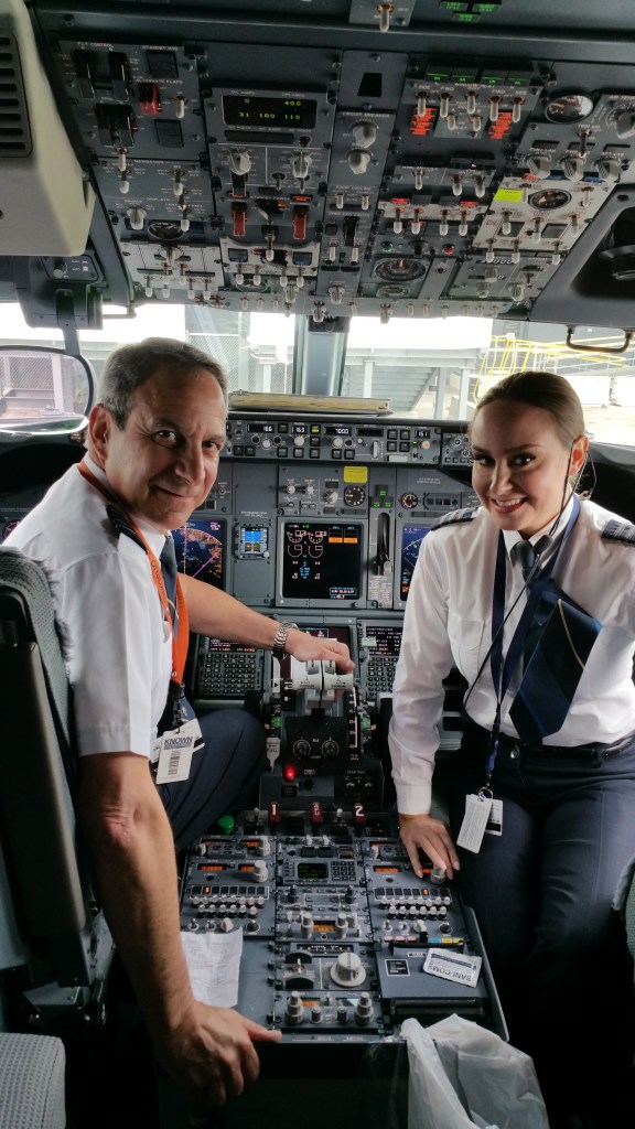 This is a photo of a father-daughter pilot team in the flight deck.