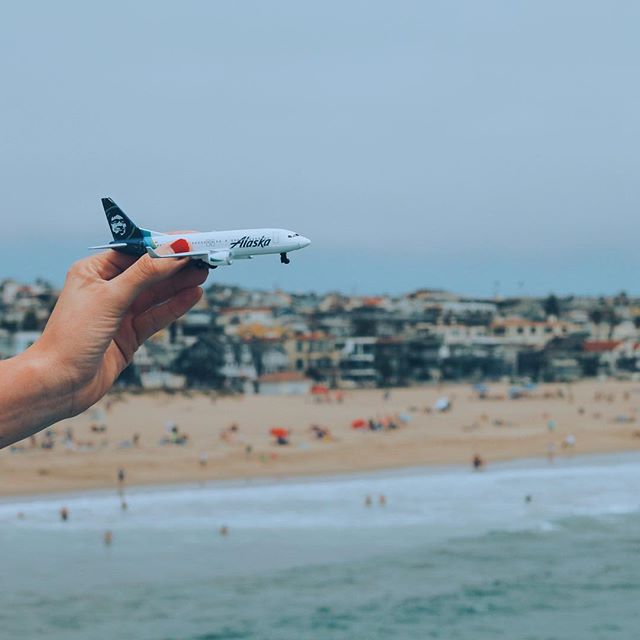This is a photo of a mini plane with a view of the beach in the background.