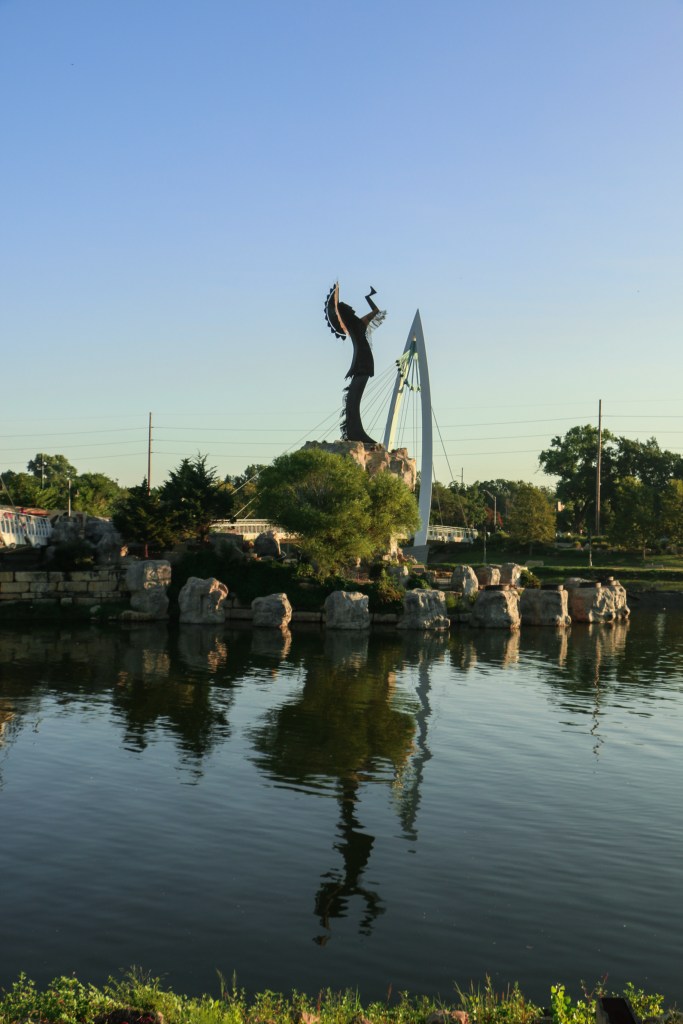 Photo of a Native American statue in the middle of the Arkansas River